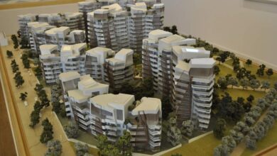 Nowoczesny model osiedla mieszkaniowego, przedstawiający unikalną architekturę wysokich budynków w otoczeniu zieleni, idealny dla inwestycji deweloperskich i optymalizacji przestrzeni mieszkaniowej.