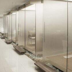 Nowoczesne kabiny sanitarne z szklanymi ściankami, eleganckie i funkcjonalne rozwiązania dla obiektów komercyjnych. Idealne do biur, centrów handlowych i innych przestrzeni publicznych.
