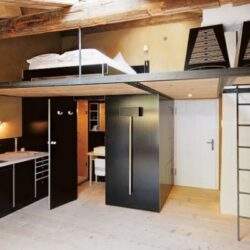 Nowe, funkcjonalne mieszkanie z wysokim sufitem i antresolą, nowoczesny design, połączone strefy kuchenne i wypoczynkowe, industrialne elementy wykończenia, idealne rozwiązanie dla młodych rodzin.