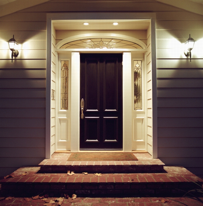 Front door of house with lights at night