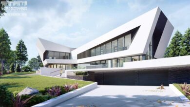 Nowoczesny budynek mieszkalny z dużymi oknami i innowacyjnym designem, otoczony zielenią, idealny do komfortowego życia.