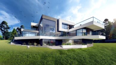 Nowoczesny dom jednorodzinny z dużymi przeszkleniami i balkonami, otoczony zielonym ogrodem, idealny dla rodzin szukających komfortu i funkcjonalności.