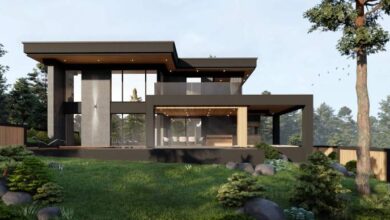 Nowa nowoczesna architektura domu jednorodzinnego z dużymi przeszkleniami i przestronnym tarasem, otoczona zielenią i drzewami, idealna dla miłośników minimalistycznego designu.